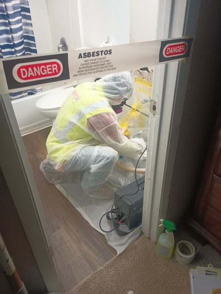 asbestos abatement worker glove bag removal